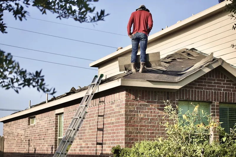 Professional roofer working on a residential roof in Somers